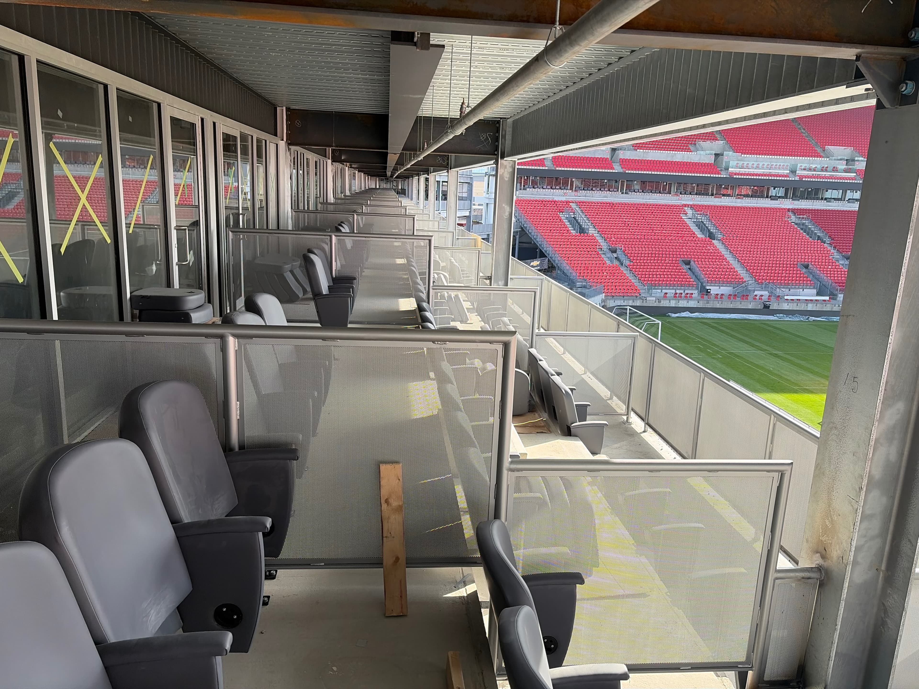Installed perforated railing panels dividing suite-level seating at BMO Field